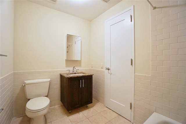 90 Bay Street Lndg Unit 4B, Staten Island, NY 10301 - full bathroom with tile walls, wainscoting, tile patterned flooring, vanity, and a tub to relax in