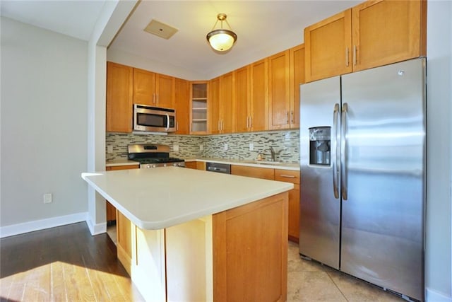 90 Bay Street Lndg Unit 4B, Staten Island, NY 10301 - kitchen featuring stainless steel appliances, light countertops, and tasteful backsplash