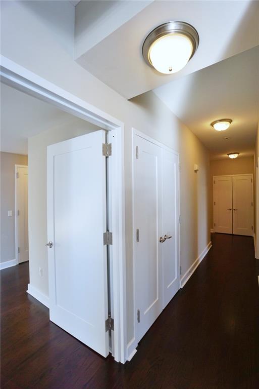 90 Bay Street Lndg Unit 4B, Staten Island, NY 10301 - hall featuring dark wood-style floors and baseboards