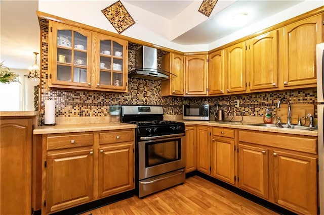 1717 Avenue N Unit 3C, Brooklyn, NY 11230 - kitchen with appliances with stainless steel finishes, wall chimney exhaust hood, light countertops, and decorative backsplash