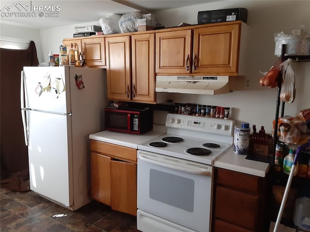 kitchen with white appliances and dark tile flooring