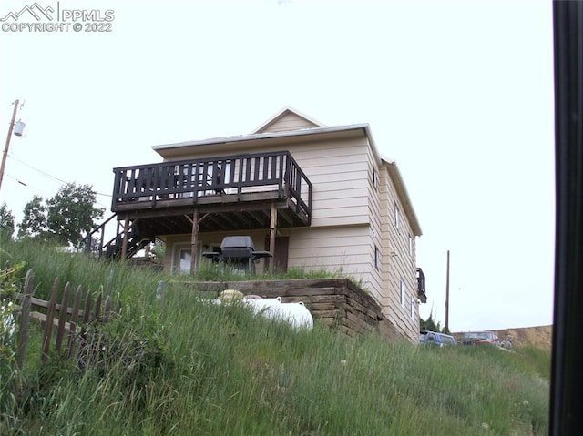 back of property featuring a wooden deck