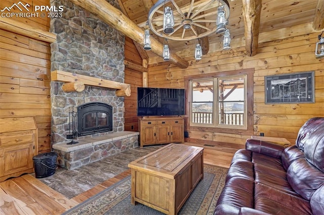 living room featuring vaulted ceiling with beams, a fireplace, and dark wood-type flooring