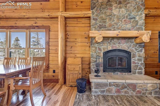 living room featuring a stone fireplace and hardwood / wood-style flooring