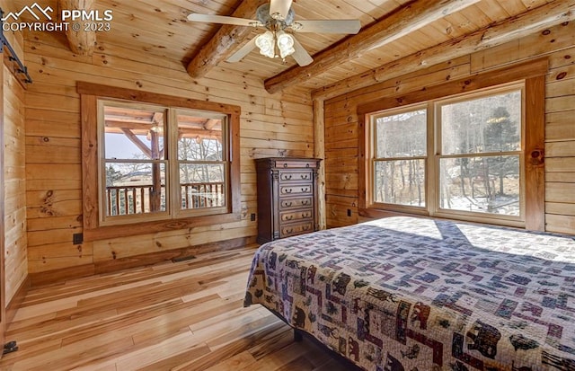 bedroom featuring beamed ceiling, wooden ceiling, multiple windows, and light wood-type flooring