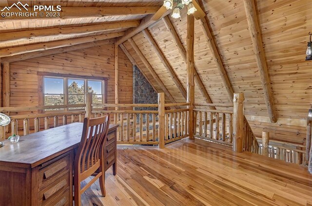 unfurnished office featuring wood ceiling, wood walls, vaulted ceiling with beams, and light wood-type flooring