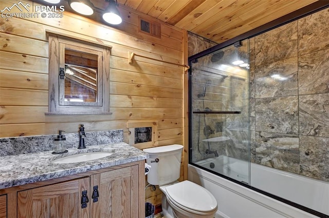 full bathroom featuring wooden walls, vanity, wooden ceiling, enclosed tub / shower combo, and toilet