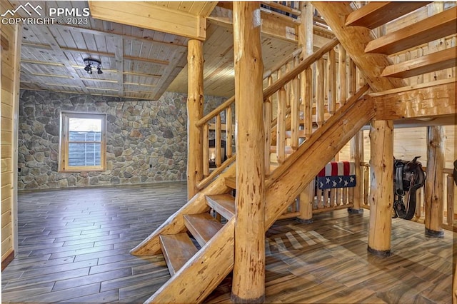 staircase with hardwood / wood-style floors and wood ceiling