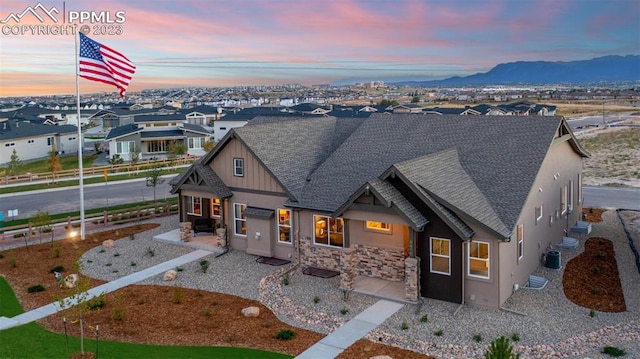 view of front of home featuring a mountain view and central air condition unit