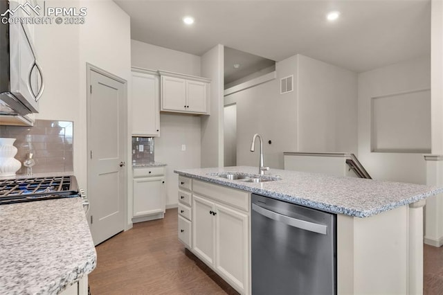 kitchen featuring white cabinetry, sink, light hardwood / wood-style flooring, stainless steel appliances, and tasteful backsplash