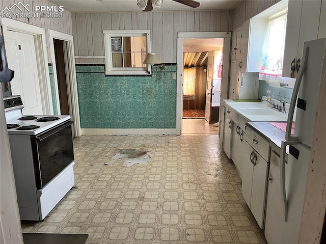 kitchen featuring ceiling fan, sink, white appliances, and light tile floors