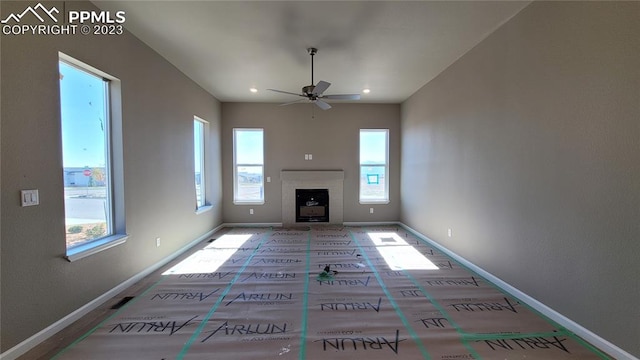 unfurnished living room with ceiling fan