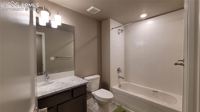 full bathroom featuring vanity, toilet, and tiled shower / bath combo