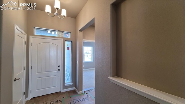 foyer entrance featuring an inviting chandelier