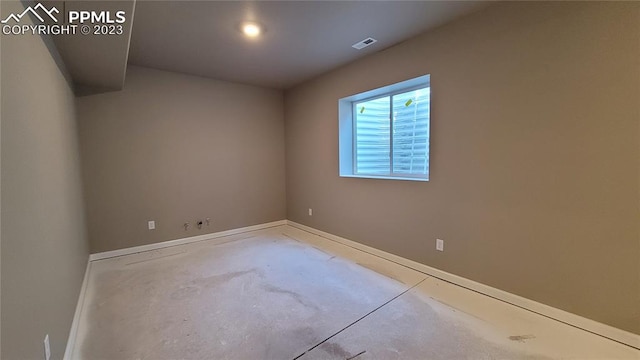 empty room with concrete flooring