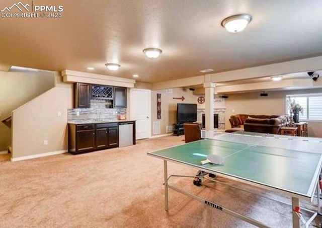 recreation room featuring light carpet