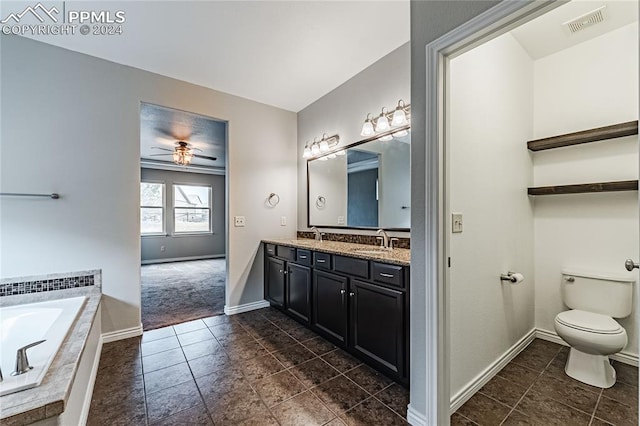 bathroom with ceiling fan, a relaxing tiled tub, toilet, and tile patterned floors