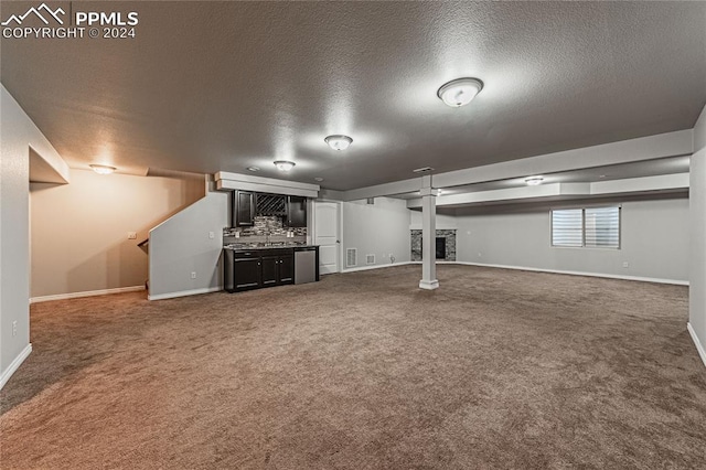 basement featuring a textured ceiling and carpet floors