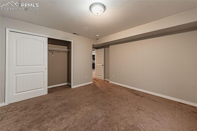 unfurnished bedroom with a closet and carpet flooring