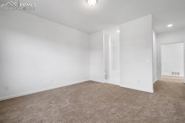 empty room with light colored carpet