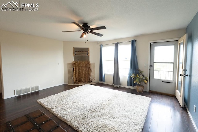 bedroom featuring ceiling fan, multiple windows, and dark wood-type flooring