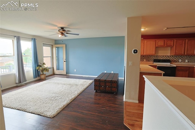 living room featuring dark hardwood / wood-style floors and ceiling fan