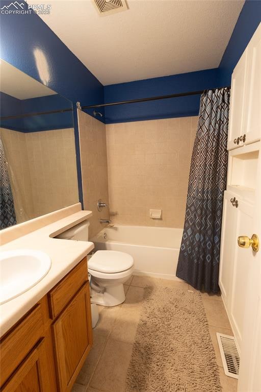 full bathroom with toilet, tile flooring, shower / tub combo, and vanity