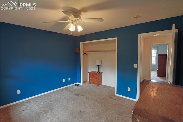 unfurnished bedroom featuring ceiling fan, carpet floors, and a closet