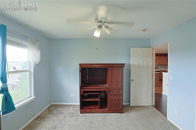 unfurnished bedroom with light carpet and ceiling fan