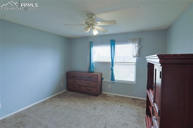 unfurnished bedroom with light carpet and ceiling fan