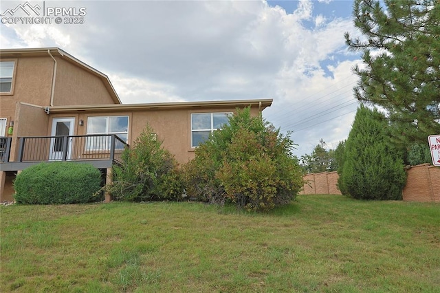 view of side of home featuring a yard