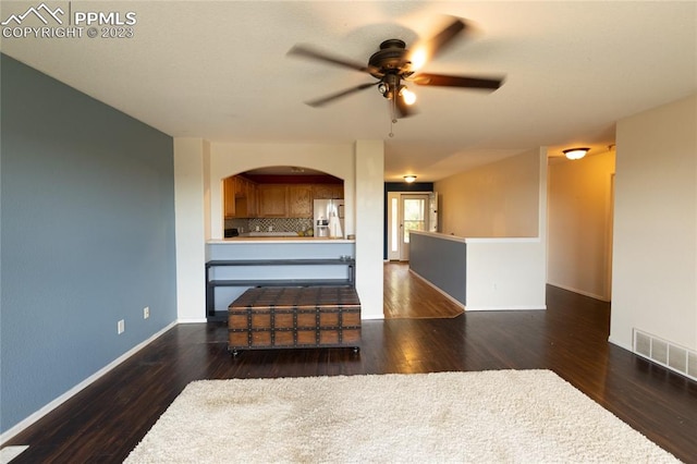 unfurnished living room featuring dark hardwood / wood-style floors and ceiling fan