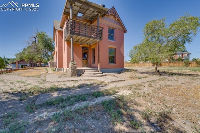 back of house with a balcony