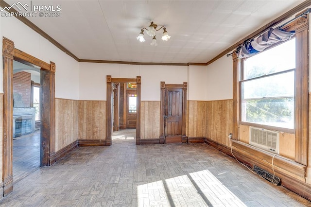 spare room with light parquet flooring and ornamental molding