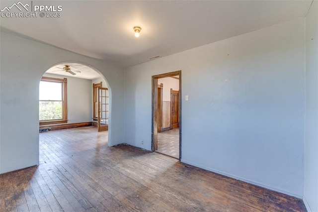 spare room with ceiling fan and wood-type flooring