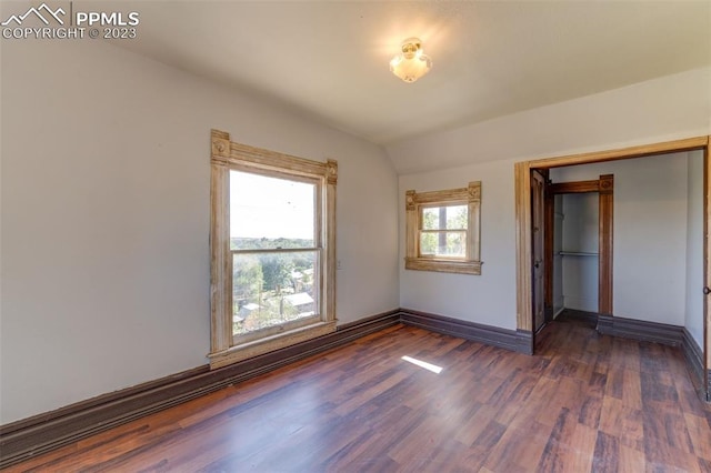 unfurnished bedroom featuring a closet and dark hardwood / wood-style flooring