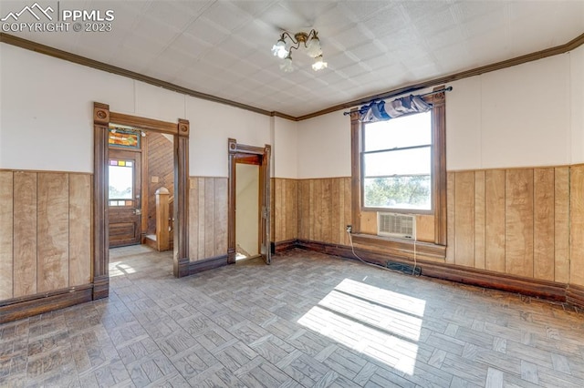 empty room with wooden walls, parquet flooring, and a wealth of natural light