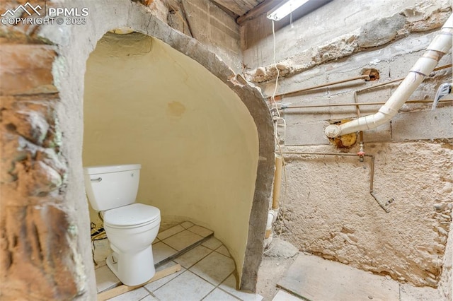 bathroom featuring tile floors and toilet