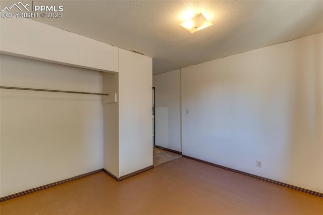 unfurnished bedroom with a closet and a textured ceiling