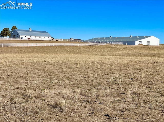 view of yard with a rural view