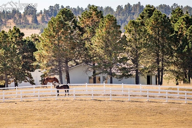 exterior space featuring a garage and a rural view