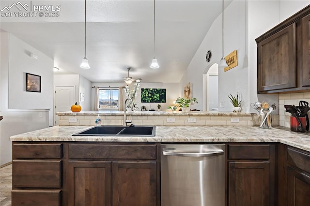 kitchen with stainless steel dishwasher, ceiling fan, sink, dark brown cabinetry, and light stone countertops