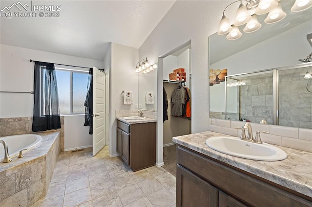 bathroom featuring lofted ceiling, tile flooring, plus walk in shower, and double sink vanity