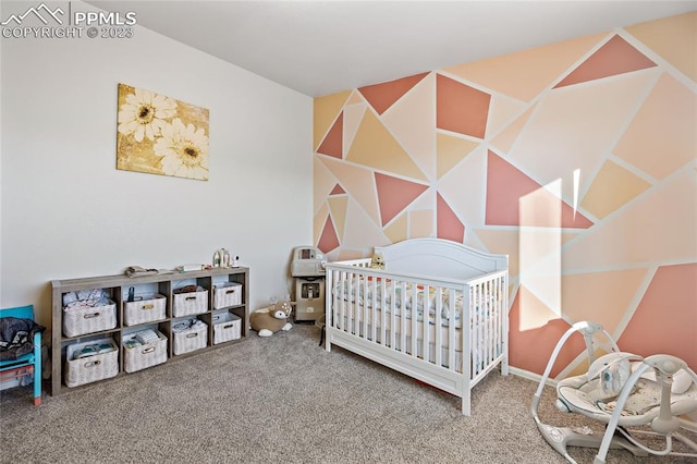 carpeted bedroom with a nursery area