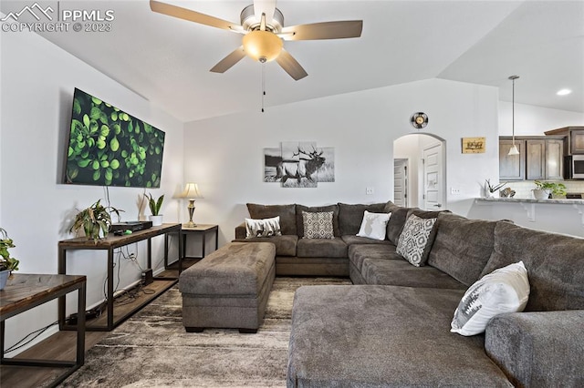 living room with dark hardwood / wood-style floors, ceiling fan, and lofted ceiling