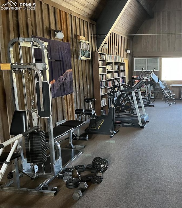 gym featuring wood ceiling, vaulted ceiling, and wood walls