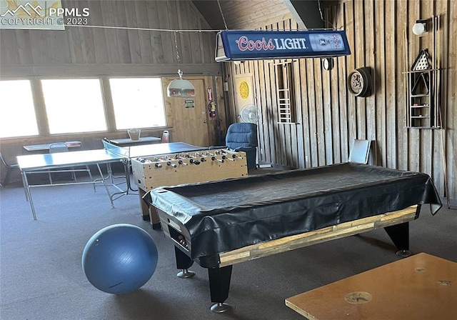 recreation room with carpet flooring, high vaulted ceiling, billiards, and wood walls