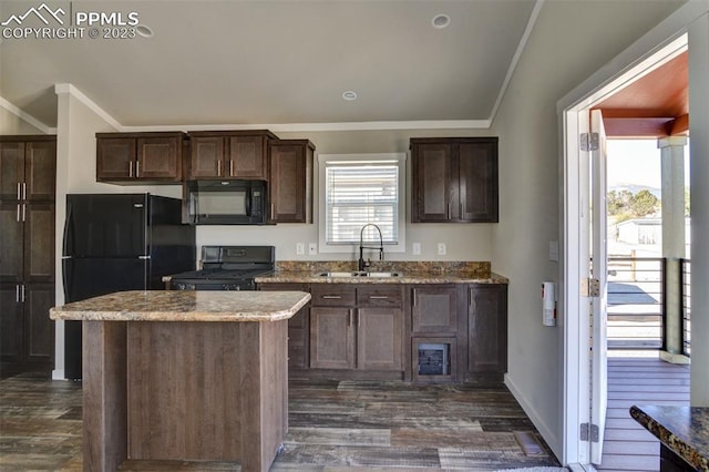 kitchen with ornamental molding, sink, a kitchen island, and black appliances