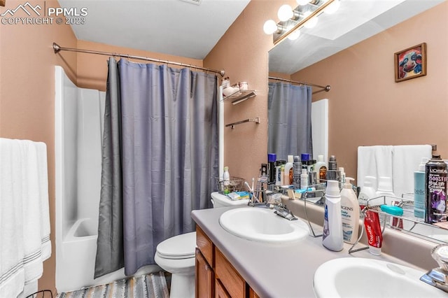 full bathroom with vanity, toilet, and shower / tub combo