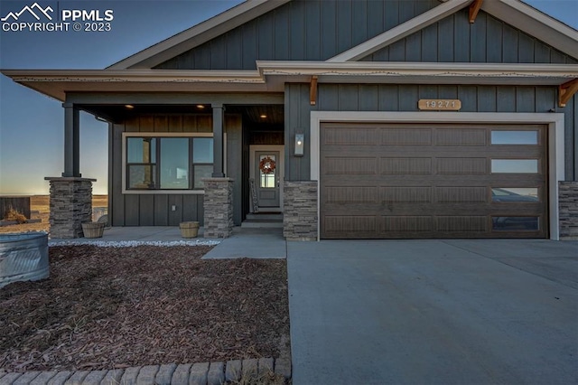 craftsman-style home featuring covered porch and a garage